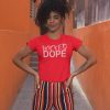 Woman wearing red Wicked Dope t-shirt and striped pants